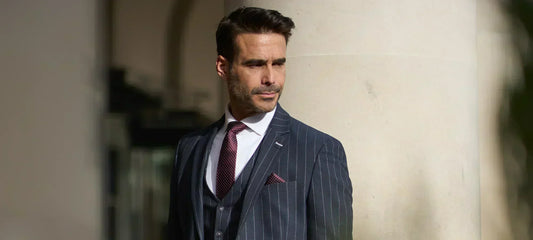 Gentleman in outside in a Cavani suit with leather travel bag